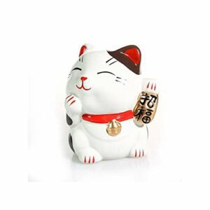 Figura de gato japonés Maneki Neko con collar rojo y campana, sosteniendo un cartel dorado.